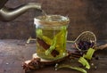 Delicious Hot herbal tea:linden, dog rose, mint, cinnamon. Hot Tea being poured into a glass Royalty Free Stock Photo