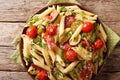 Delicious hot penne pasta with ham, cherry tomatoes, zucchini an Royalty Free Stock Photo