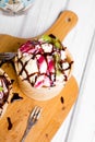 Delicious ice cream in a cup with chocolate sauce and tasty fruits Royalty Free Stock Photo