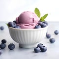 Delicious ice cream with fresh blueberries in bowl on light background.