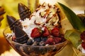 Delicious  ice cream with fruits, chocolate, nuts in glass bowl. Close up Royalty Free Stock Photo