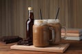 Delicious iced coffee with chocolate syrup on wooden table