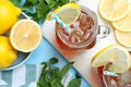Delicious iced tea with lemon and mint on light blue background, flat lay Royalty Free Stock Photo