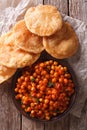 Delicious Indian Chana masala and puri close-up. Vertical top vi