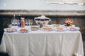 Delicious italian appetizers on table at wedding reception outdoors. Caviar, seafood, canapes, champagne and wine glasses on table Royalty Free Stock Photo