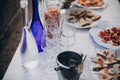 Delicious italian appetizers on table at wedding reception outdoors. Caviar, seafood, canapes, champagne and wine glasses on table Royalty Free Stock Photo