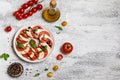 Delicious italian caprese salad with ripe tomatoes, fresh basil and mozzarella cheese on wooden rustic background. Italian caprese Royalty Free Stock Photo