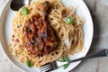 Braised italian chicken legs with delicious tomato sauce and spaghetti on a plate Royalty Free Stock Photo