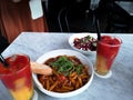 Delicious Italian dish - Red Sauce penne pasta and quinoa salad and fresh juices Royalty Free Stock Photo