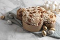 Delicious Italian Easter dove cake (Colomba di Pasqua) and decorated eggs on white marble table