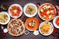 Delicious Italian food table scene on a dark wood background Royalty Free Stock Photo