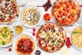 Delicious Italian food table scene, above view on a white wood background Royalty Free Stock Photo