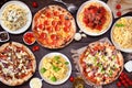 Delicious Italian food table scene, top view on a dark wood background Royalty Free Stock Photo