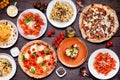 Delicious Italian food table scene on a dark wood background Royalty Free Stock Photo
