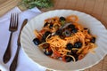 Delicious italian pasta spaghetti with anchovies on a bowl on a table.