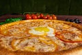 Delicious Italian pizza with egg close-up Royalty Free Stock Photo