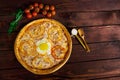 Delicious Italian pizza with egg top view close-up Royalty Free Stock Photo