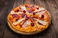 Delicious italian pizza with salami, bacon and parmesan Royalty Free Stock Photo