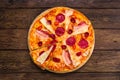 Delicious italian pizza with salami, bacon and parmesan Royalty Free Stock Photo