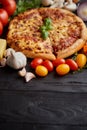 Delicious italian pizza served on black wooden table Royalty Free Stock Photo