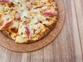 Delicious pizza served on wooden table