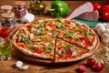 Delicious italian pizza served on wooden table. sliced pizza. tasty pizza composition Royalty Free Stock Photo