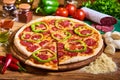 Delicious italian pizza served on wooden table. sliced pizza. tasty pizza composition Royalty Free Stock Photo