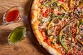 Delicious italian pizza served on wooden table. top view, close up Royalty Free Stock Photo