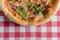 Delicious italian pizzas served on wooden table with red plaid table cloth Royalty Free Stock Photo