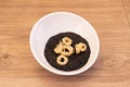 delicious Italian recipe for risotto nero with squid rings topped with flou