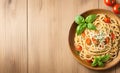 Delicious Italian Spaghetti with Basil, Herbs, and Tomatoes on a Rustic Wooden Board Background. Royalty Free Stock Photo