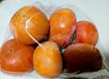 delicious japanese persimmons in pastic wrap Royalty Free Stock Photo
