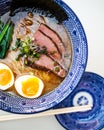 Delicious japanese ramen noodle soup in a traditional blue bowl top view Royalty Free Stock Photo