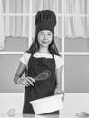 A delicious journey. chef girl in hat and apron. kid cooking food in kitchen. choosing a career. little helper use Royalty Free Stock Photo