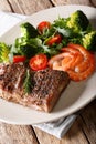 Delicious juicy barbequed steak and prawns with vegetable salad Royalty Free Stock Photo