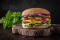 Delicious juicy cheeseburger from Brioche Bun, Aged beef cutlet, American Cheddar, Tomatoes, Gherkins, Red onions, Iceberg.