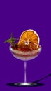 Delicious juicy citrus cocktails. Glass with sweet and sour cocktail over purple background. Creative design.
