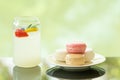 Delicious juicy fresh lemon soda on glass table Blurred leaf reflection background Royalty Free Stock Photo