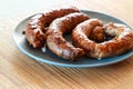 Delicious juicy grilled sausages on a plate Royalty Free Stock Photo