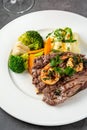 Delicious juicy grilled steak and shrimp with grilled broccoli and cauliflower.  Surf and Turf style Royalty Free Stock Photo