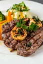 Delicious juicy grilled steak and shrimp with grilled broccoli and cauliflower. Surf and Turf style