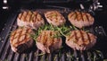 Delicious juicy meat steak cooking on grill. Prime beef fry on electric roaster, rosemary, black pepper, salt. Slow Royalty Free Stock Photo