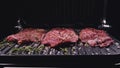 Delicious juicy meat steak cooking on grill. Prime beef fry on electric roaster, rosemary, black pepper, salt. Slow Royalty Free Stock Photo