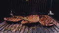 Delicious juicy meat steak cooking on grill. Prime beef fry on electric roaster, rosemary, black pepper, salt. Slow Royalty Free Stock Photo