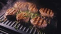 Delicious juicy meat steak cooking on grill. Prime beef fry on electric roaster, rosemary, black pepper, salt. Slow Royalty Free Stock Photo