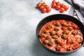 Delicious juicy Meatballs in tomato sauce are cooked in a castiron pan. Concrete background. Copy space Royalty Free Stock Photo