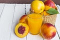 Delicious and juicy peach nectarina with glass of juice on white wooden table Royalty Free Stock Photo