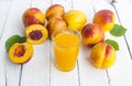 Delicious and juicy peach nectarina with glass of juice on white wooden table Royalty Free Stock Photo