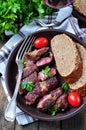 Delicious juicy rare beef steak with rye bread bran Royalty Free Stock Photo