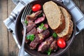 Delicious juicy rare beef steak with rye bread bran Royalty Free Stock Photo